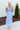 Front view of model wearing the Living In A Fairytale Midi Dress that has periwinkle organza pleated fabric, periwinkle lining, midi length, a square neck, and adjustable straps.