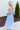 Side view of model wearing the Living In A Fairytale Midi Dress that has periwinkle organza pleated fabric, periwinkle lining, midi length, a square neck, and adjustable straps.