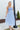 Front view of model wearing the Living In A Fairytale Midi Dress that has periwinkle organza pleated fabric, periwinkle lining, midi length, a square neck, and adjustable straps.