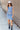 Full body front view of model wearing the Long Beach Dress that has light blue ribbed fabric, midi length, a round neckline, and thick straps.