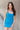 Front view of model wearing the Get Ready Dress that has stretchy turquoise fabric, mini length, a round neckline, spaghetti straps.