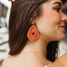 Side view of model wearing the Let It Go Earring in Pink which features pink yarn designed with pink and amber stones.
