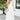 Front view of model wearing the Summer Romance Maxi Dress that has white fabric, maxi length, white lining, a ruffled hem, a plunge neckline, layered upper details, ruffle straps, and back corset ties