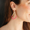 Side view of model wearing the Augustine Earrings in Pink which features gold braided teardrop with color-block pink braided details.