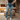 Front view of model wearing theThe Ceros: Meet Me Downtown Jeans which features medium blue denim wash, front zipper with button closure, mid-rise, two front pockets, two back pockets, belt loops and cropped flare with distressed hem.