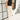 Full body front view of model wearing the Ellison Denim Cargo Pants in Light Taupe that have light taupe cotton denim fabric, two front pockets, a side cargo loop detail, an elastic waistband and wide legs.