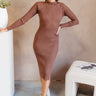 Full body front view of model wearing the Keep Up Ribbed Midi Dress that has mocha brown ribbed fabric, midi length, a high neckline and fitted long sleeves