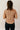 Back view of model wearing the Sienna Taupe Basic Short Sleeve Top which features taupe knit fabric, a scooped hem, a round neckline and short sleeves.