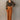 Full body front view of model wearing the Lexie Camel Wide Leg Pants that have camel lightweight fabric, a seam down each front leg, a slight v waistline, a back zipper closure, and wide legs.
