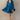 Full body front view of model wearing the Lottie Blue Satin Long Sleeve Mini Dress that has deep blue satin fabric, mini length, a v-neck, and long balloon sleeves.