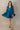 Full body front view of model wearing the Lottie Blue Satin Long Sleeve Mini Dress that has deep blue satin fabric, mini length, a v-neck, and long balloon sleeves.