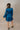 Side view of back wearing the Lottie Blue Satin Long Sleeve Mini Dress that has deep blue satin fabric, mini length, a v-neck, and long balloon sleeves.
