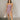 Full body front view of model wearing the Britney Purple Camo Strapless Mini Dress that has purple sheer fabric, camoflauge print, a slit on the side with ruffle details, and a strapless neckline.