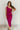 Full body front view of model wearing the Tiffany Fuchsia Ruched One-Shoulder Midi Dress that has fuchsia stretchy semi-satin fabric, ruched details, a one-shoulder neckline, and a side zipper.