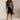 Full body front view of model wearing the Joan Black Faux-Leather Mini Skirt that has black faux leather, mini length, a front zipper with a tortoise button closure, a slight v waistband, and side pockets.