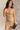 Front view of model wearing the Amber Gold Cowl Neckline Sleeveless Mini Dress which features gold shimmer fabric, mini length, gold lining, a cowl neckline, adjustable straps, and a monochromatic back zipper with a hook closure.