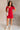 Full body front view of model wearing the Olivia Red Corduroy Short Sleeve Mini Dress that has red corduroy fabric, pockets, a front zipper, a matching belt, a collar, mini length and short sleeves