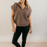 Full body front view of model wearing the Saylor Brown Sleeveless Quarter-Zip Sweatshirt that has mocha brown knit fabric, a thick hem, and a quarter zip-up with a folded neck.