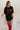 Full Front view of model wearing the Game Day Red & Black Sequin Dress that has black sequins, red sequins that say "Game Day", and black knit back, an oversized fit, short sleeves, and a round neck.