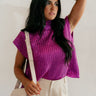 Front view of model wearing the Velma Magenta Metallic Cable Knit Sleeveless Sweater which features magenta cable knit fabric with a metallic thread design, a high neckline and a sleeveless design.