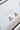 Close-up image of the everyday earrings, which are gold triangle studs.