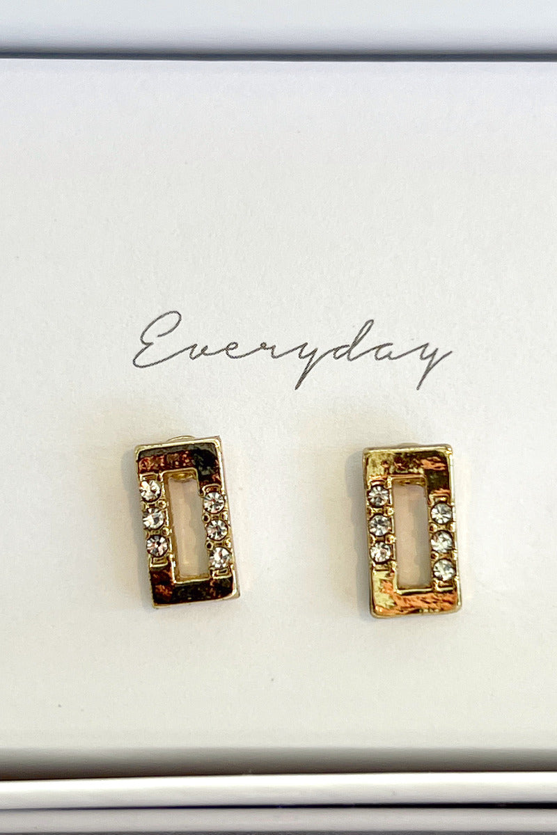 Close-up view of the 'everyday' gold rectangle earrings with rhinestones.