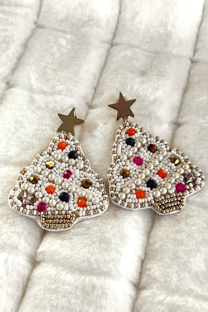 Close image of the Trim The Tree Earrings that feature white Christmas tree pendants with with multi color beaded embellishments.