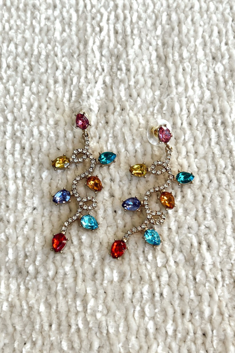 Close image of the Light Up My World Earrings that feature a Christmas light design with multi-colored stones.