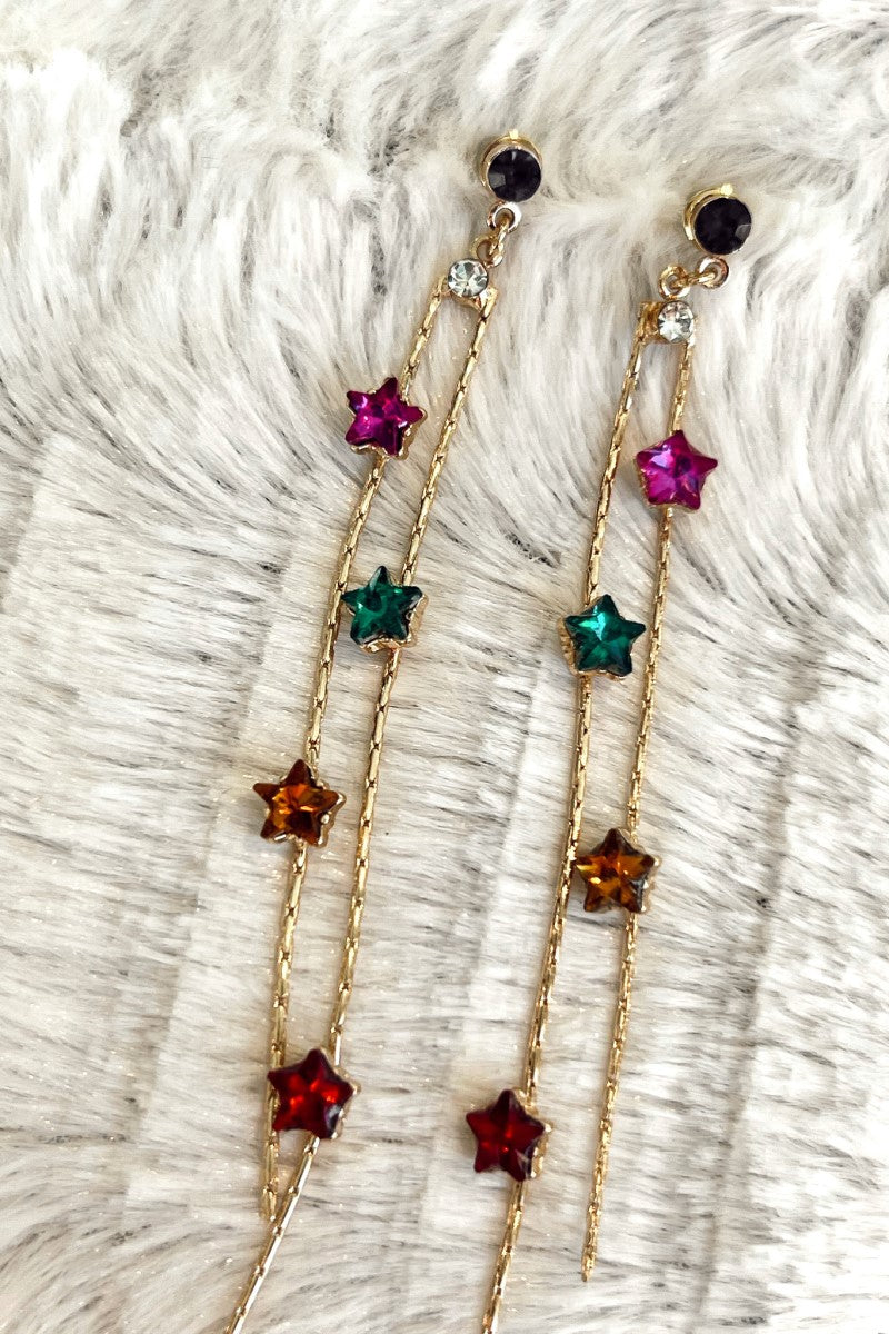 Close image of the Wish Upon A Star Earrings feature multi-colored star-shaped stones on gold chains.
