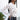 Side view of model wearing the New Rhythm Top, that has cream and beige fabric with a dimensional pattern, ruching ties on the hem, a round neckline and long sleeves.