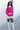 Full body front view of model wearing the Future Is Bright Sweater in Pink, that has hot pink ribbed knit fabric, a cropped waist, a round neckline, and balloon sleeves with cuffed wrists