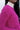 Close side view of model wearing the Future Is Bright Sweater in Pink, that has hot pink ribbed knit fabric, a cropped waist, a round neckline, and balloon sleeves with cuffed wrists