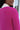 Close back view of model wearing the Future Is Bright Sweater in Pink, that has hot pink ribbed knit fabric, a cropped waist, a round neckline, and balloon sleeves with cuffed wrists