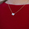 The Be Bold Necklace features gold chain layer with a clear stone surrounded by a white border. 