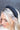 Top view of model wearing the Sadie Headband in Black, that features a structured band with a satin lining and a quilted exterior with a top twist.