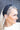 Side view of model wearing the Sadie Headband in Black, that features a structured band with a satin lining and a quilted exterior with a top twist.
