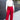 Full body view of model wearing the Endless Love Pant which features red satin fabric, geometric pattern, zipper and hook closure, two back pockets, belt loops and straight wide leg.