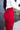 Side view of model wearing the Endless Love Pant which features red satin fabric, geometric pattern, zipper and hook closure, two back pockets, belt loops and straight wide leg.