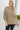 Close up view of model wearing the Just Relax Top In Olive which features green fabric, a round neckline, and balloon long sleeves.