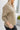 Side view of model wearing the Just Relax Top In Olive which features green fabric, a round neckline, and balloon long sleeves.