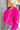 Side view of model wearing the Make A Statement Jacket which features hot pink soft shag fabric, hidden button closures, two front pockets, cropped waist and long balloon sleeves. The jacket is open. 