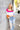 Full body view of Whitney Color-Block Sweater which features pink, white, blue, purple and orange ribbed stripe fabric, a cropped waist, a square neckline, and long sleeves.