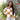 Close up view of model wearing the Check This Out Sweater which features white and camel knit fabric with a checkered pattern, a round neckline, a cropped waist and long sleeves.