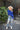 Full body view of model wearing the Talk About It Sweater which features royal blue ribbed knit fabric, a cropped waist, a round neckline and balloon sleeves with cuffed wrists.