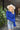 Close up view of model wearing the Talk About It Sweater which features royal blue ribbed knit fabric, a cropped waist, a round neckline and balloon sleeves with cuffed wrists.