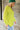 Side view of model wearing the Ready Or Not Sweater In Lime which features lime knit fabric, slits on the hem, a round neckline, drop shoulders and balloon long sleeves with fitted wrists.