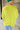 Back view of model wearing the Ready Or Not Sweater In Lime which features lime knit fabric, slits on the hem, a round neckline, drop shoulders and balloon long sleeves with fitted wrists.