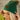 Front view of model wearing the Anchorage Beanie in Green, that has forest green knit fabric with a stitched pattern, a front patch that says "C.C exclusives", and a brown faux-fur pompom.