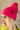 Side view of model wearing the Fireside Beanie in Pink, that features pink knit fabric, a folded cuff with a brown "C.C" patch, and a pink pompom.
