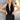 Close up view of model wearing the Skylar Satin Dress in Black which features black satin fabric, halter neckline with a tie, ruching on the sides, back zipper with hook closures and lining.
